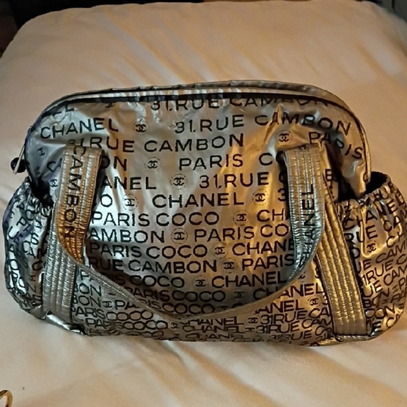 CHANEL Handbags - Chanel Metallic Silver Paris Print Travel Bag